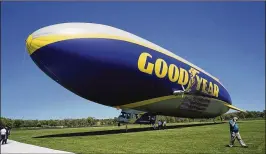  ?? DAKE KANG / ASSOCIATED PRESS ?? Goodyear is training pilots of its iconic blimps to fly new airships in northeast Ohio after the company retired the last of its old blimp fleet. Its sleek, modern airships are designed by Germany’s Zeppelin conglomera­te. In short, Goodyear is getting...