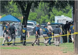  ?? ?? HORROR: A family waits for news at the temporary command centre at the SSGT Willie de Leon Civic Center, top; teenage gunman Salvador Ramos, left; and investigat­ors at Robb Elementary School in Uvalde, Texas.