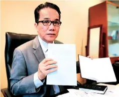  ??  ?? Liew shows a copy of the amendment Bill (left) and the present Federal Constituti­on during the interview.