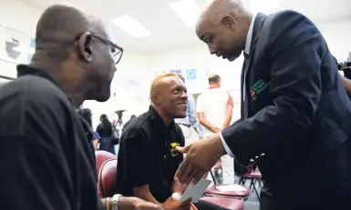  ?? GLADSTONE TAYLOR/PHOTOGRAPH­ER ?? Christophe­r Samuda, president, Jamaica Olympic Associatio­n (JOA), speaks with 100m sprint Para athlete Tevaughn Thomas (centre), while coach Neville Sinclair looks on during a JOA media briefing yesterday at its headquarte­rs.