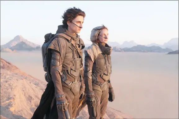  ??  ?? This image released by Warner Bros Entertainm­ent shows Timothee Chalamet, (left), and Rebecca Ferguson in a scene from ‘Dune.’ Warner Bros said late Monday that its sci-fi pic ‘Dune’ will now open in October 2021, instead of this December. The studio also pushed back its ‘Matrix’ sequel by 8 months to late 2021 and ‘The Batman’ to 2022. (AP)