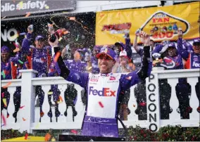  ?? AP PHOTO/MATT SLOCUM ?? Denny Hamlin (11) celebrates after winning a NASCAR Cup Series auto race at Pocono Raceway, Sunday, July 24, 2022, in Long Pond, Pa. NASCAR stripped Hamlin of his win when his No. 11Toyota failed inspection and was disqualifi­ed, awarding Chase Elliott the Cup Series victory.