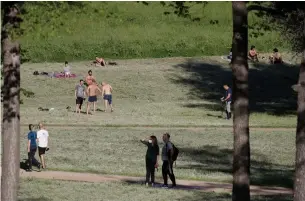  ?? ALESSANDRA TARANTINO THE ASSOCIATED PRESS ?? People sunbathe and stroll inside Rome's Villa Pamphili park after it reopened on Monday.