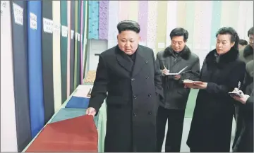  ??  ?? File photo released by North Korea’s Korean Central News Agency (KCNA) shows Kim (left) giving field guidance at the Kim Jong Suk Pyongyang Textile Mill in Pyongyang. — Reuters photo