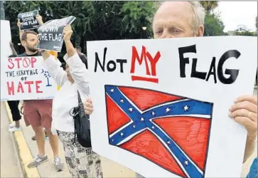  ?? Mladen Antonov
AFP/Getty Images ?? PROTESTERS rally in Columbia, S.C., over the weekend. “This f lag has become too divisive and too hurtful for too many of our fellow Americans,” Republican National Committee Chairman Reince Priebus said.