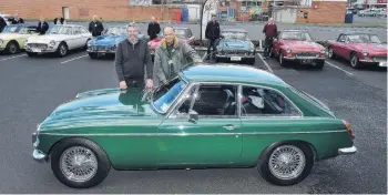  ?? PHOTO: GREGOR RICHARDSON ?? On show . . . MGCGT owners Ross Osborne (left), of Mosgiel, and New Zealand MGC Register secretary and historian Ian Grant, of Matamata, display the MGCGTs and Roadsters on show in Dunedin yesterday.