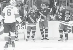  ?? FRANK FRANKLIN II/AP ?? The Rangers' Mika Zibanejad, center, celebrates with Mats Zuccarello, second from left and Chris Kreider after scoring a goal as Panthers' Alexander Petrovic looks on Tuesday.