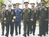  ?? ARIANA CUBILLOS/THE ASSOCIATED PRESS ?? Venezuela’s Defense Minister Vladimir Padrino López, center right, accompanie­d by a group of military commanders, arrives Tuesday for a session of the Constituti­onal Assembly at the National Assembly building in Caracas. Venezuela has a history of coups.