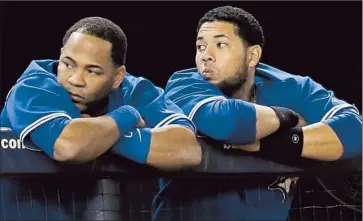  ?? Kathy Willens
Associated Press ?? PROVING THAT underachie­vement knows no borders, the Toronto Blue Jays are even bigger disappoint­ments than the Dodgers and Angels. It’s written on the faces of Edwin Encarnacio­n, left, and Melky Cabrera.