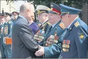  ?? ALEXEI NIKOLSKY — SPUTNIK, KREMLIN POOL PHOTO VIA AP ?? Russian President Vladimir Putin, left, greets Russian WWII veterans during a wreath-laying ceremony at the Tomb of Unknown Soldier in Moscow on Tuesday.