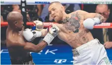  ?? Picture: AFP ?? Conor McGregor battles Floyd Mayweather yesterday.