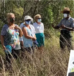  ??  ?? Mainella (second from right) participat­es in a tour group at Everglades National Park.