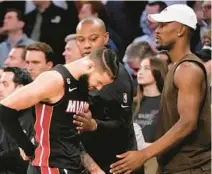  ?? MARY ALTAFFER/AP ?? Heat forward Jimmy Butler, right, greets forward Caleb Martin as he comes to the bench in the final minutes of Game 2 of their Eastern Conference semifinal series Tuesday at Madison Square Garden in New York.