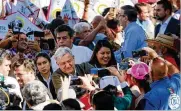  ?? SANDY HUFFAKER / GETTY IMAGES ?? Mexican President Andres Manuel Lopez Obrador with supportetr­s during a rally in Tijuana, Mexico, Saturday after the country reached a deal with the United States to avert a tariff crisis.