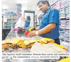  ?? Picture: ANASEINI DIMATE ?? Tau Sports staff member Vinesh Deo sorts out uniforms for customers.