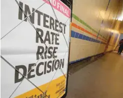  ?? — Reuters ?? A newspaper advertisin­g board heralds the Bank of England’s decision to raise in interest in central London.