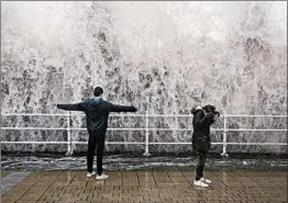  ?? AARON CHOWN/AP ?? A wave driven by powerful winds that raked Western Europe crashes against the sea wall in Aberystwyt­h, Wales, in southweste­rn Great Britain on Wednesday.