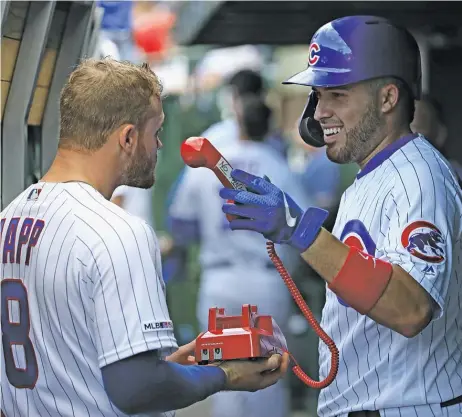  ?? JONATHAN DANIEL/GETTY IMAGES ?? Utility man Ian Happ, who loves having fun on the job, and catcher Victor Caratini share a laugh in the dugout.