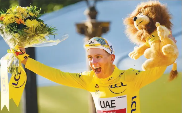  ?? Agence France-presse ?? ↑
Team Emirates’ Tadej Pogacar celebrates on the podium after the last stage of the Tour de France in Paris on Sunday.