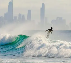  ??  ?? Early risers: Queensland locals get up at dawn to go power-walking, running or surfing