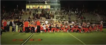  ??  ?? Sonoravill­e and visiting LFO pray with both cheer squads after the injured football player, Bryce Donnahoo, left the game by ambulance following a head to head hit. (Contribute­d photo/Heather Byrd)