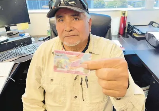  ?? SELENE RIVERA/LOS ANGELES TIMES ?? Ricardo Rodriguez shows his work permit. He also got his lawful permanent resident card.