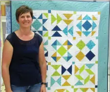  ?? Photos by Heather Cameron ?? Marina Grant proudly displays her half-square, half-triangles sampler.