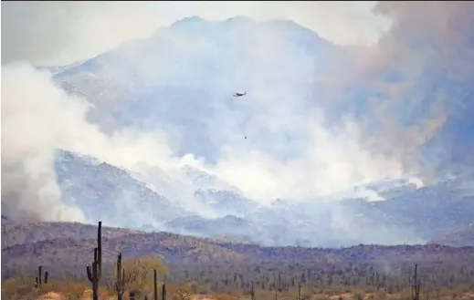  ?? PHOTOS BY PATRICK BREEN/THE REPUBLIC ?? A helicopter is seen over the Tonto National Forest on Sunday.