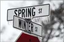  ?? CORY MORSE — MLIVE.COM — THE GRAND RAPIDS PRESS VIA AP ?? Freezing rain coats road signs for Winter and Spring streets in Spring Lake, Mich., on Monday.