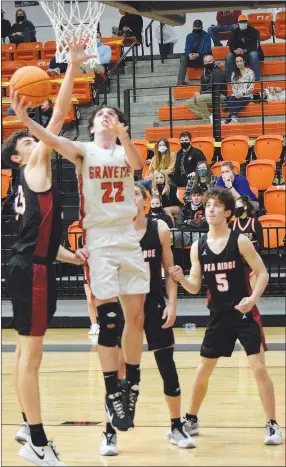  ?? Westside Eagle Observer/MIKE ECKELS ?? Johnny Dunfee (22) goes for a reverse layup during the fourth quarter of the Jan. 5 Gravette-Pea Ridge conference contest in Gravette. Dunfee missed the shot but the ball deflected into the hands of teammate Dakota Sizemore who was able to maneuver the ball into position for a three-point shooting attempt.