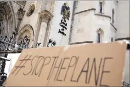  ?? ALASTAIR GRANT — THE ASSOCIATED PRESS FILE ?? A placard is left outside the High Court in London, where the ruling on Rwanda deportatio­n flights is taking place on Monday.