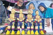  ?? AFP ?? Barcelona fans display figurines of (LR) Lionel Messi, Andres Iniesta, Gerard Pique and Luis Suarez with their hands tied and reading “freedom to the political prisoners” in reference to detained Catalan officials, at the Camp Nou on Saturday.