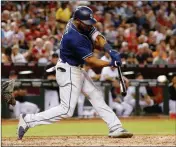  ?? ASSOCIATED PRESS ?? SAN DIEGO PADRES’ MANUEL MARGOT connects for a tworun triple against the Arizona Diamondbac­ks during the fourth inning of a baseball game Friday in Phoenix.