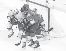  ?? CHARLES TRAINOR JR ctrainor@miamiheral­d.com ?? Florida’s Kevin Connauton (44) and Carolina’s Cedric Paquette battle in the first period.