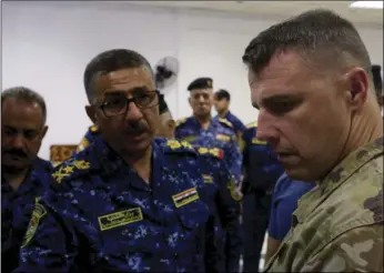  ??  ?? Lieutenant General Raid Shaker Jawlat (center), of the Iraqi federal police talks with Colonel Pat Work of the U.S. Army’s 82nd airborne division as they look at a map of Mosul, in Mosul, Iraq on Friday. AP PHOTO/BALINT SZLANKO