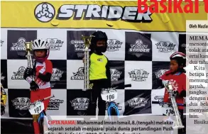  ?? — Gambar Bernama ?? CIPTA NAMA: Muhammad Imran Ismail, 8, (tengah) melakar sejarah setelah menjuarai piala dunia pertanding­an Push Bike Piala Strider 2018 di Amerika Syarikat.