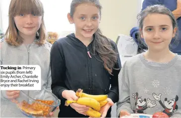  ??  ?? Tucking in Primary six pupils (from left) Emily Archer, Chantelle Bryce and Rachel Irving enjoy their breakfast