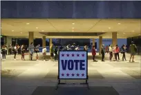  ?? JAY JANNER — AUSTIN AMERICAN-STATESMAN, FILE ?? Voters wait in line at a polling place at the Lyndon B. Johnson School of Public Affairs in Austin, Texas, on election night Nov. 8.