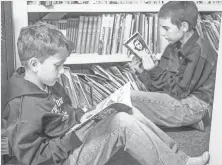  ?? KEITH GRAHAM AND NEIL CHAPUT DE SAINTONGE ?? Students read at Pine Grove School in Garfield County, Mont.
