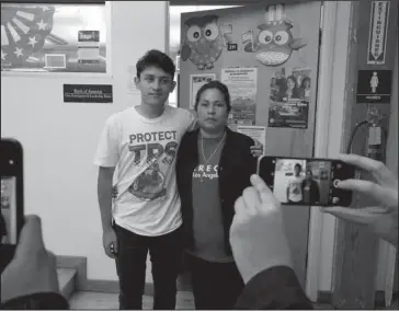  ?? The Associated Press ?? PROTECTION­S ENDING: U.S. citizen Benjamin Zepeda, 14, with his mother Lorena Zepeda, who benefits from Temporary Protected Status have their photo taken after a news conference Monday in Los Angeles. The Trump administra­tion said Monday it is ending...