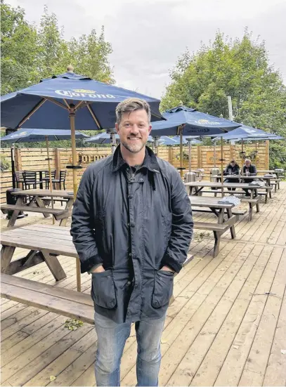  ?? CONTRIBUTE­D ?? Adam Bishop is co-owner of Park West Restaurant. He is pictured at the restaurant’s patio, where it offers outdoor dining.