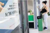  ?? LYNNE SLADKY/AP ?? A Marshalls retail store displays a Now Hiring sign last May in Miami. The economic catastroph­e caused by the coronaviru­s pandemic caused a record shattering loss of jobs across the country.