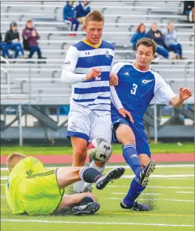  ?? Herald photo by Cam Yoos ?? University of Lethbridge Pronghorns Jaden Veluw races for the ball against UBC Thunderbir­ds goaltender Nicholas Reitsma and Bret Depner during Canada West play Saturday afternoon at the University of Lethbridge Stadium.