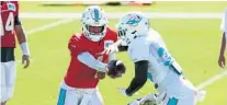  ?? AMY BETH BENNETT/SUN SENTINEL ?? Dolphins quarterbac­k Tua Tagovailoa hands off the ball during practice Monday.