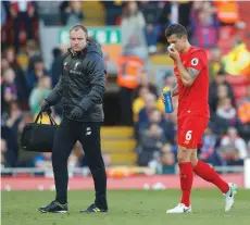  ?? — Reuters ?? Liverpool’s Dejan Lovren goes off injured.