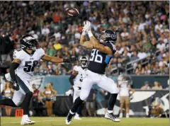  ?? MICHAEL PEREZ — THE ASSOCIATED PRESS ?? The Titans’ Anthony Firkser, right, catches a touchdown pass as the Eagles’ L.J. Fort trails during the first half Thursday in Philadelph­ia.