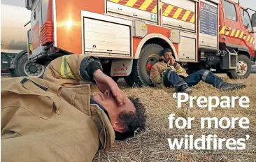  ??  ?? Takaka volunteer firefighte­rs Callum Reid, left, and Grant Lawrence are exhausted at the end of their shift in the first week of the blaze that started in Pigeon Valley on February 5.