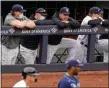  ?? KATHY WILLENS - THE ASSOCIATED PRESS ?? New York Yankees players watch from the dugout railing during the seventh inning of Sunday’s game against the Tampa Bay Rays in New York. From left, are Luke Voit, Brett Gardner, Jay Bruce, who retired after the game, and Clint Frazier.