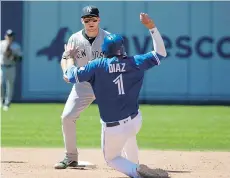  ?? FRED THORNHILL/THE CANADIAN PRESS ?? New York Yankees second baseman Brandon Drury waits to apply the tag on Toronto Blue Jays infielder Aledmys Diaz during recent action. The two are now on the same team after Drury was acquired by the Jays in the deal for starting pitcher J.A. Happ.