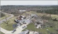  ?? PICTURES: DAVID GOLDMAN/AP ?? DESTRUCTIO­N: Top, residents retrieve personal items from their damaged home in Beauregard, Alabama. Above, debris litters a property after a house was hit by the tornado.